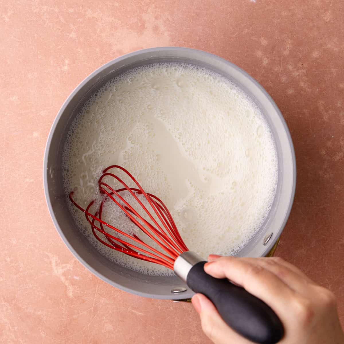 Milk is whisked together with the sugar and cornstarch in a small saucepan.
