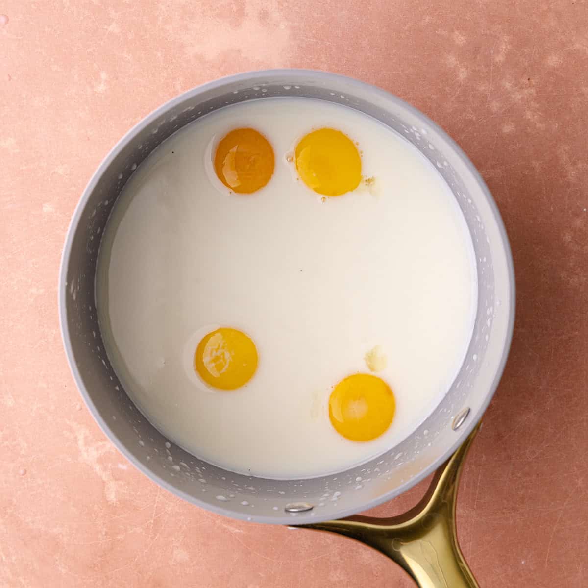 Four egg yolks are added to the milk sugar cornstarch mixture.