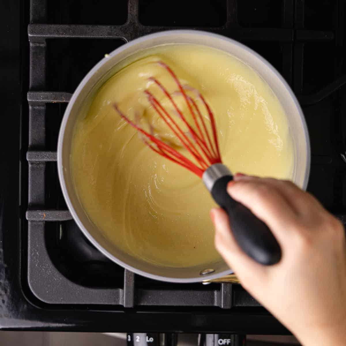 Vanilla pastry cream is cooked until thick.