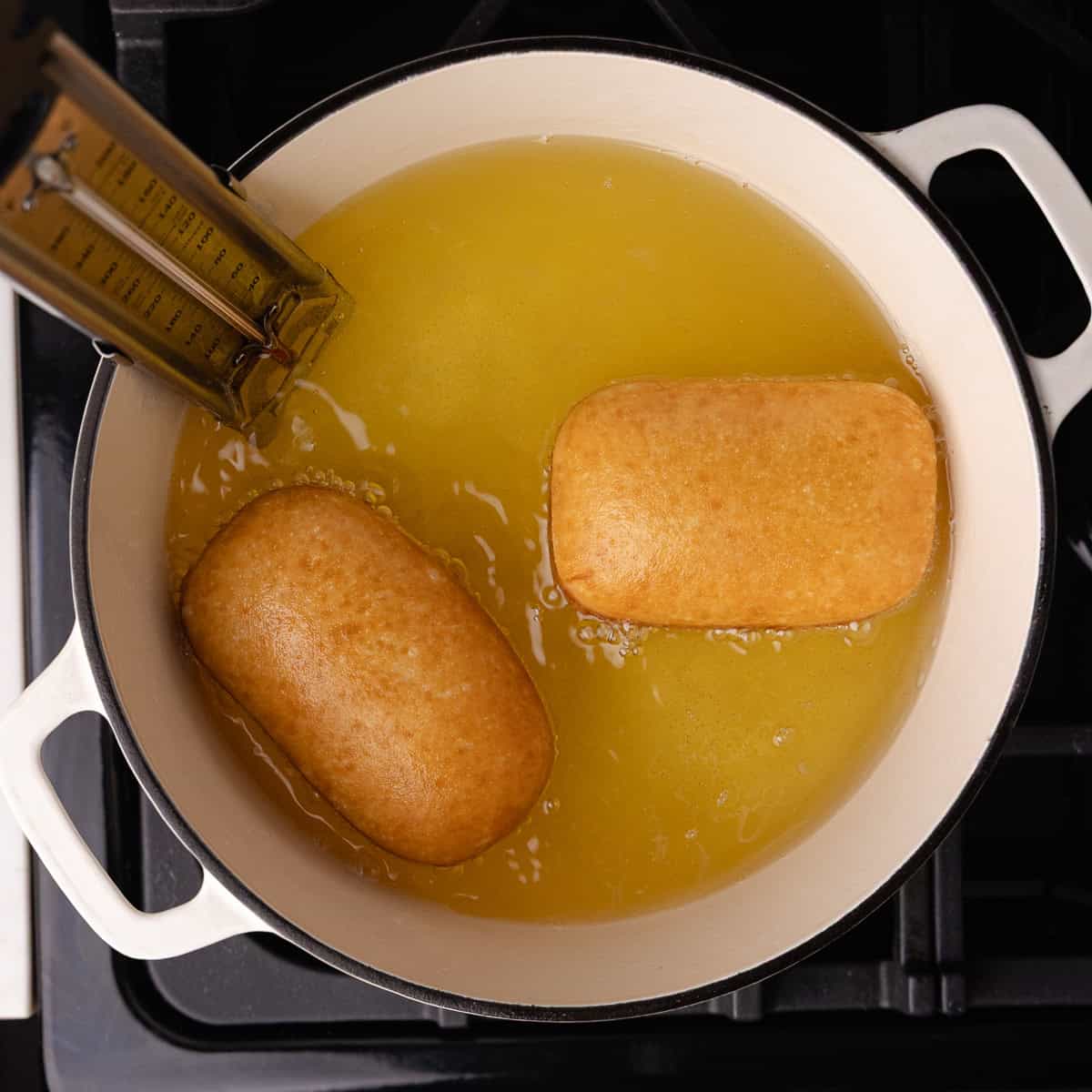Maple bars are fried until golden brown in a Dutch oven.