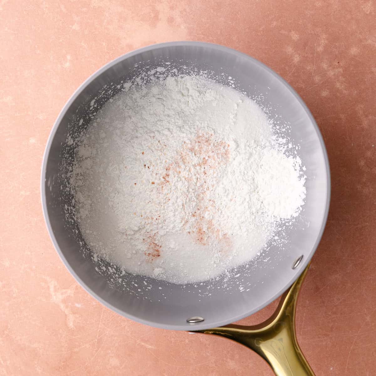 Sugar, cornstarch and salt is whisked together in a small pot.