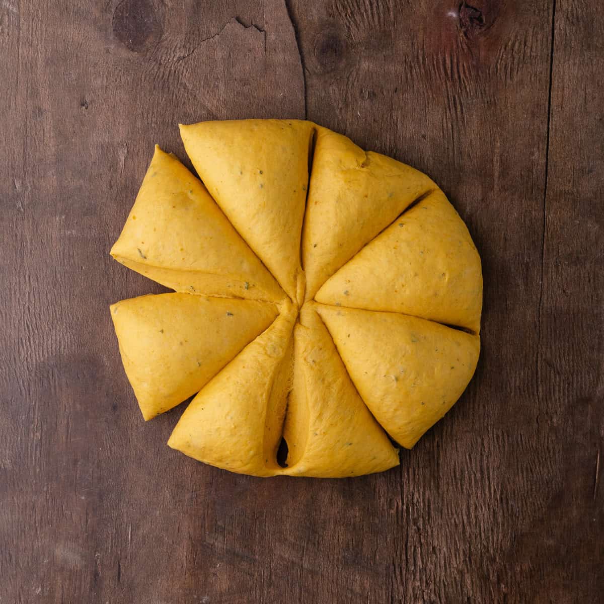 Soft pumpkin sage pretzels dough is divided into 8 equal pieces.