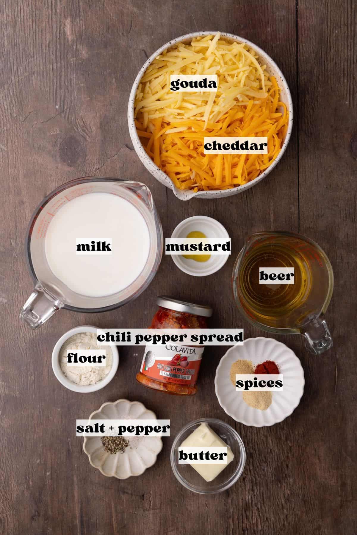 Spicy cheese beer sauce ingredients which include butter, flour, onion powder, garlic powder, smoked paprika, milk, beer, grated gouda, grated cheddar, mustard, hot chili spread sauce, salt and pepper.