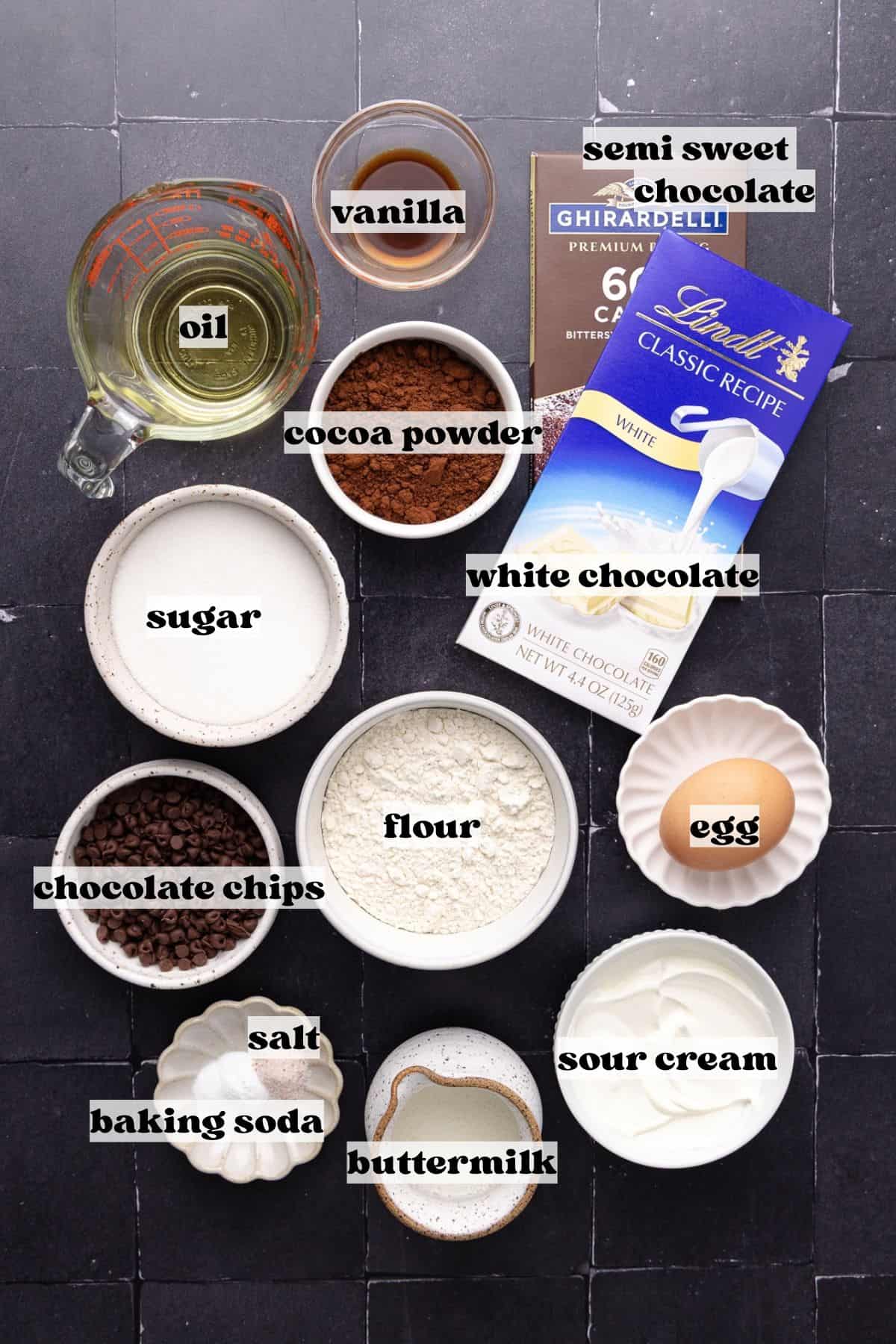 Spider web baked chocolate donut ingredients which include, flour, Dutch-process cocoa powder, baking soda, salt, olive oil, sour cream, buttermilk, egg, vanilla, mini semi-sweet chocolate chips, semi-sweet chocolate and white chocolate.